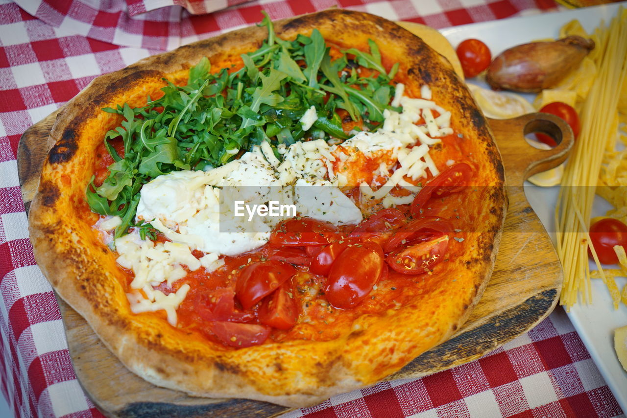 High angle view of pizza served on table