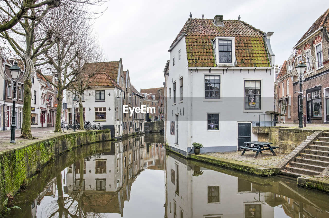 CANAL AMIDST BUILDINGS IN TOWN