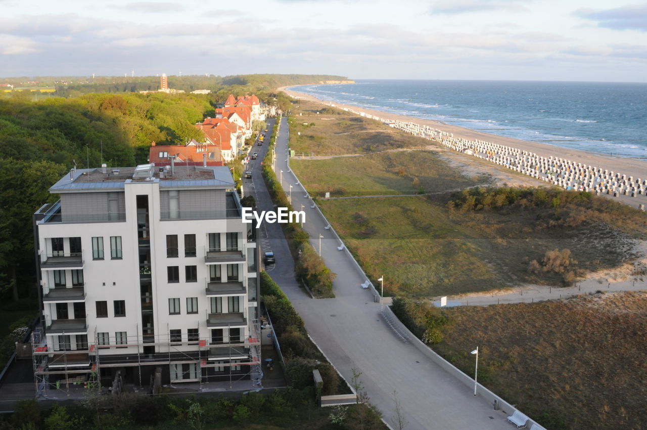 High angle view of buildings by sea against sky