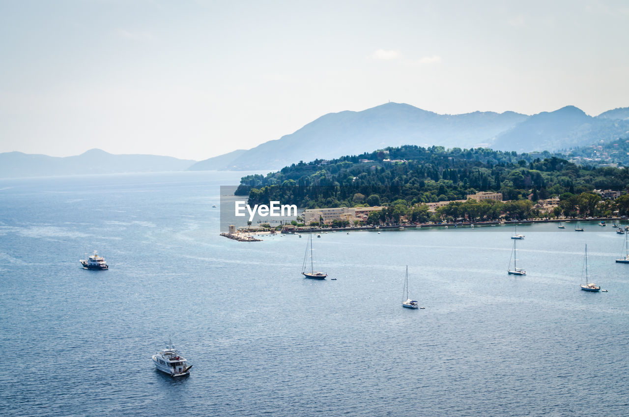 Scenic view of sea and mountains against sky