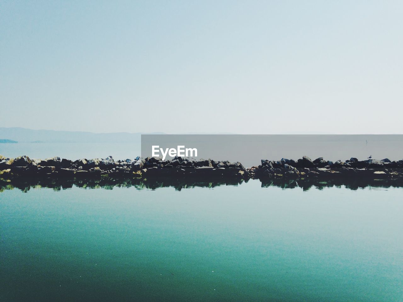 Scenic view of lake trasimeno against sky