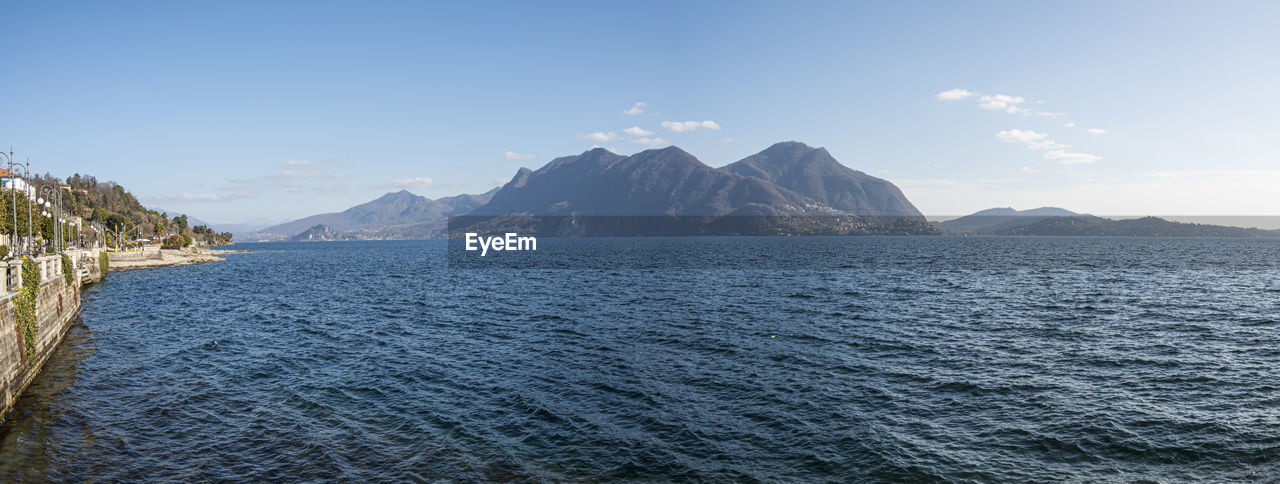 Extra wide angle view of the lakeside of intra and the lake maggiore