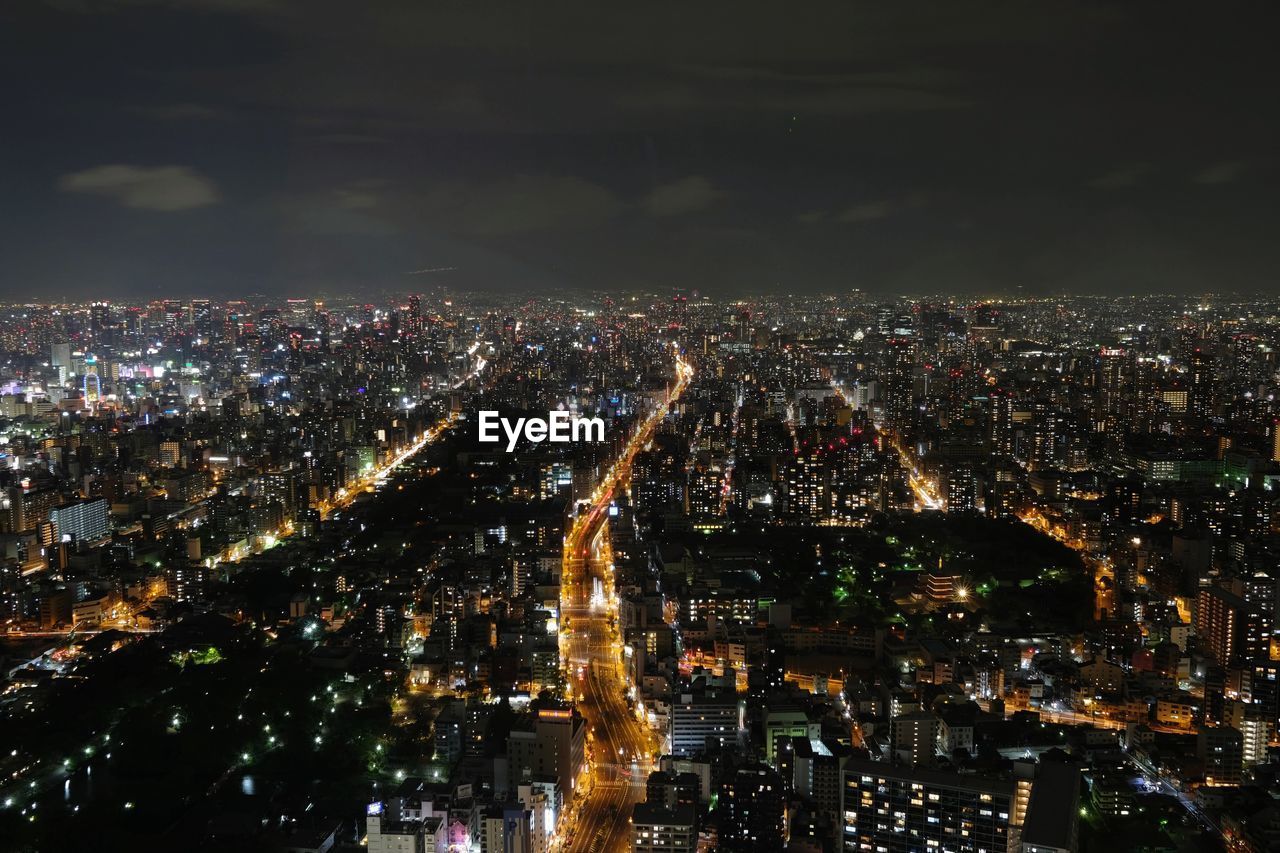 High angle view of illuminated city buildings at night