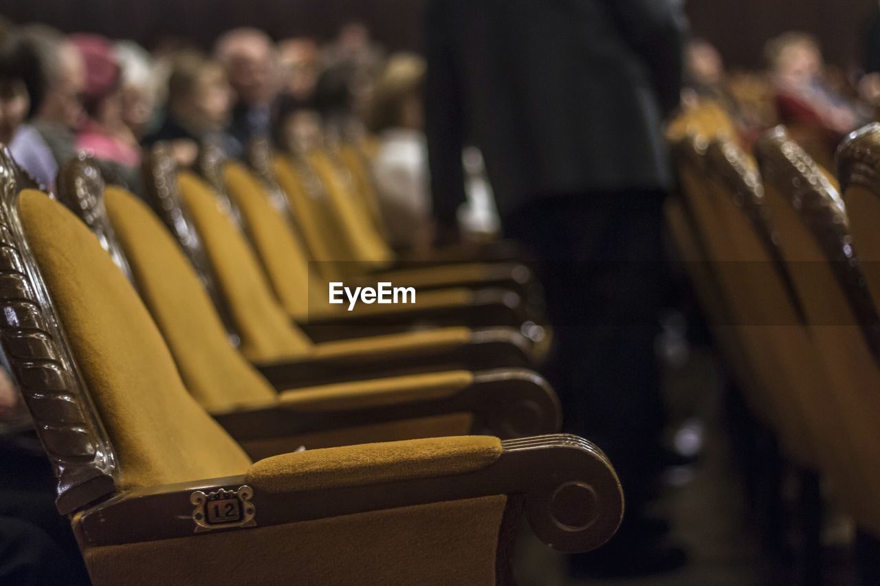 Close-up of yellow chairs in theater