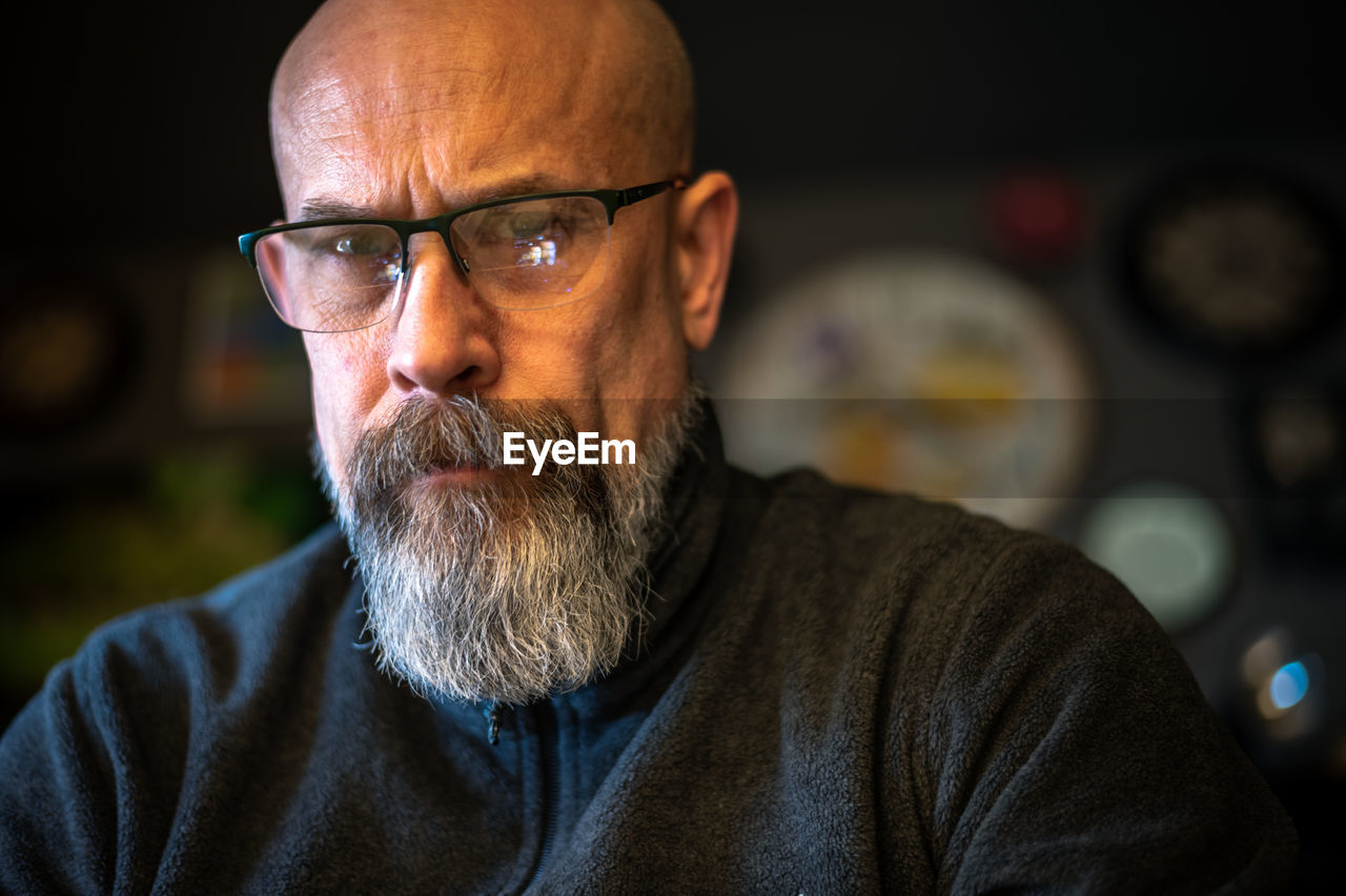 Older man with gray beard looking serious