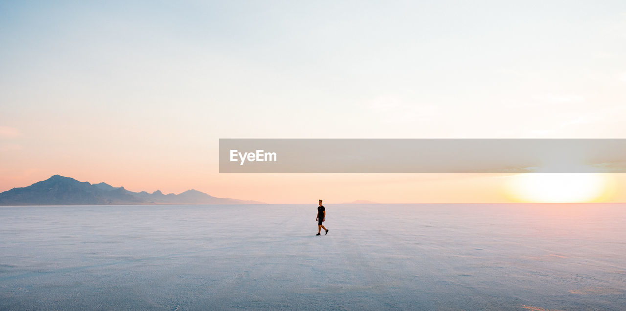 Full length of man walking on land during sunset