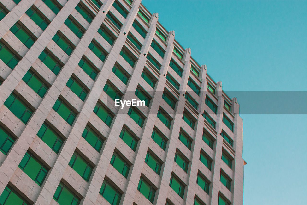 Low angle view of building against clear blue sky