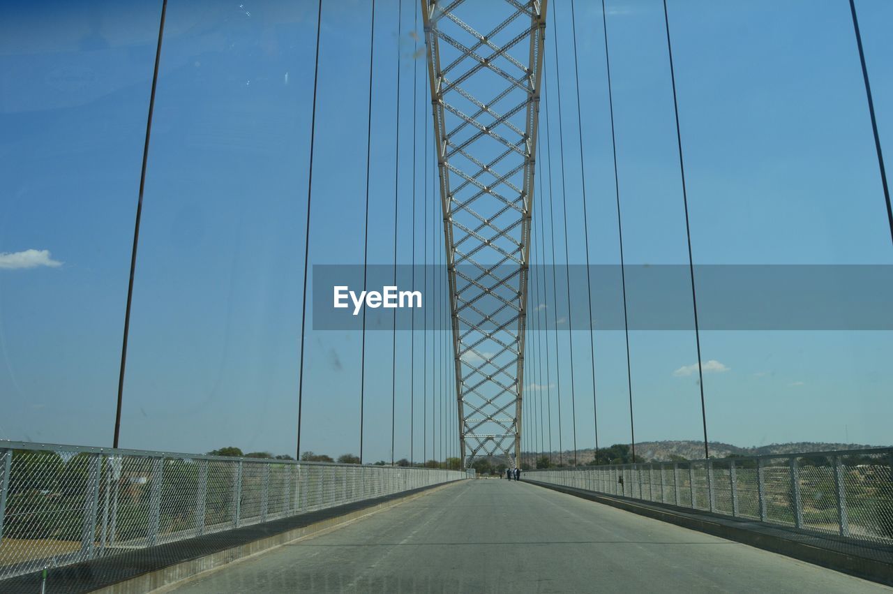Bridge against sky seen through windshield