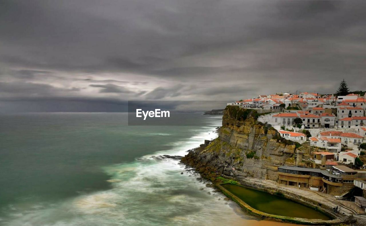 Scenic view of sea and buildings against sky