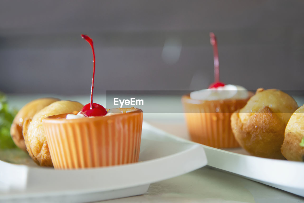 food and drink, food, fast food, dessert, baked, sweet food, produce, sweet, cake, cupcake, freshness, no people, plate, indoors, muffin, fruit, unhealthy eating, table, close-up, pastry, snack, temptation, breakfast, dish, focus on foreground