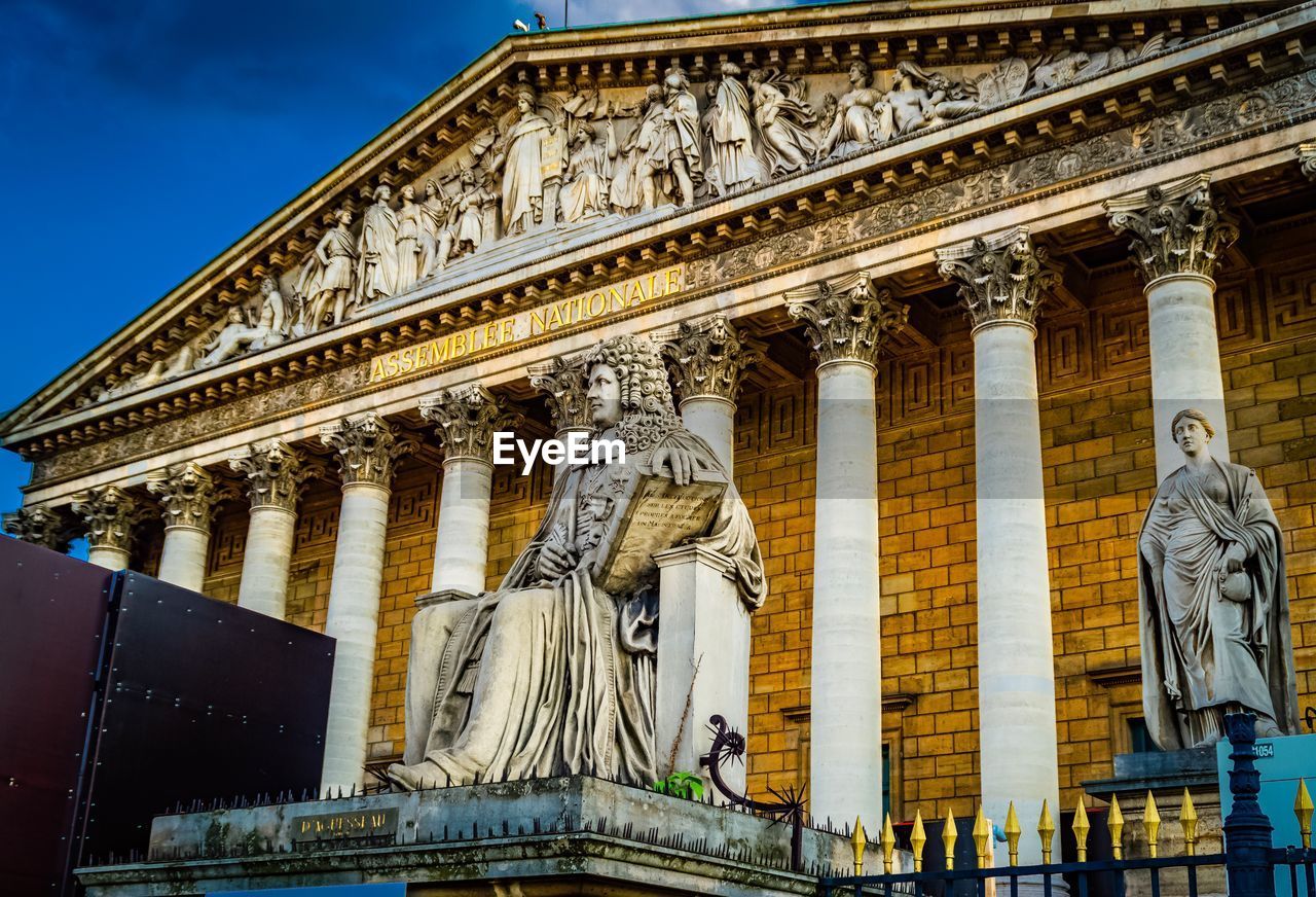 LOW ANGLE VIEW OF STATUES ON BUILDING