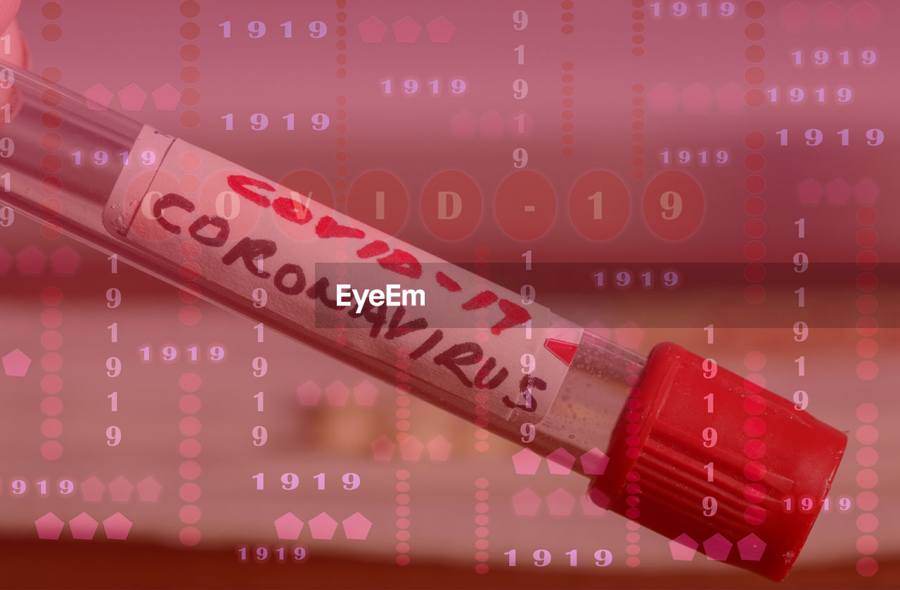 Covid-19 virus digital with blood tube background