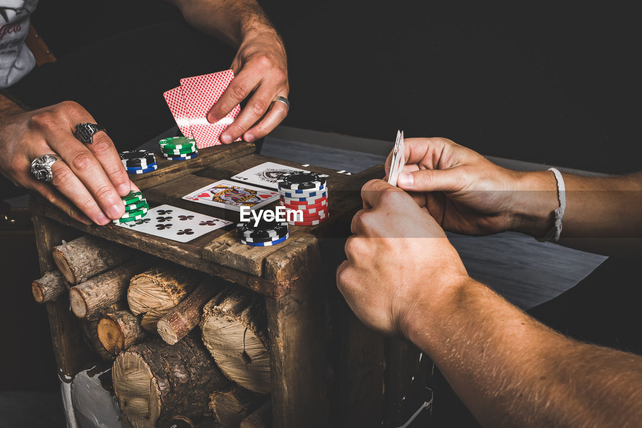 Close-up of men playing cards 