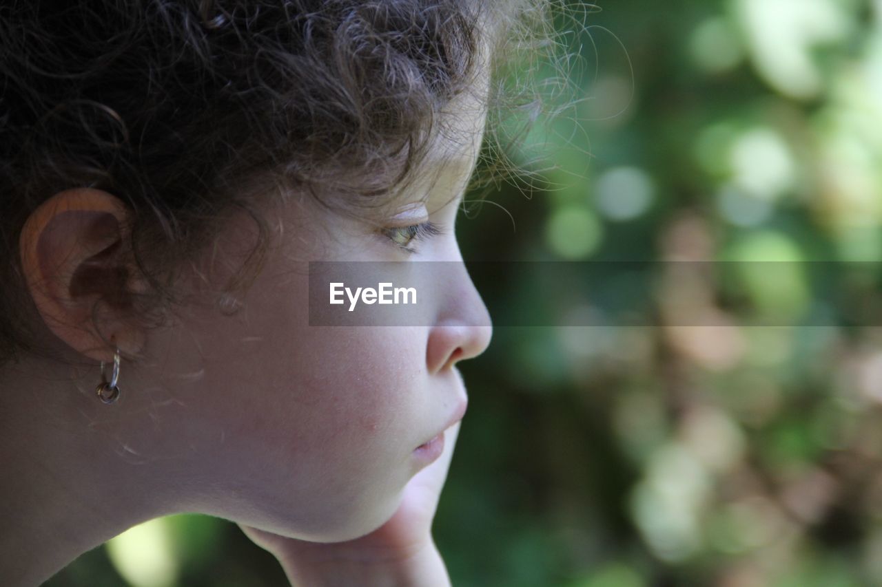 Close-up side view of girl looking away