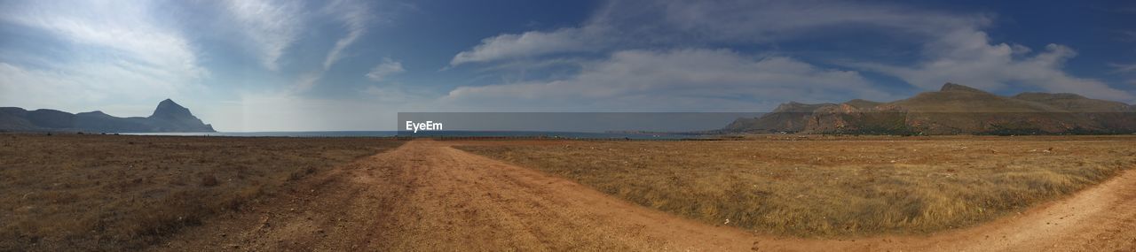 Panoramic view of land and sea against sky