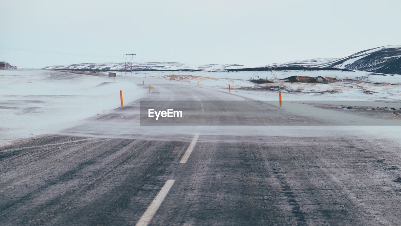 Road along snow covered landscape