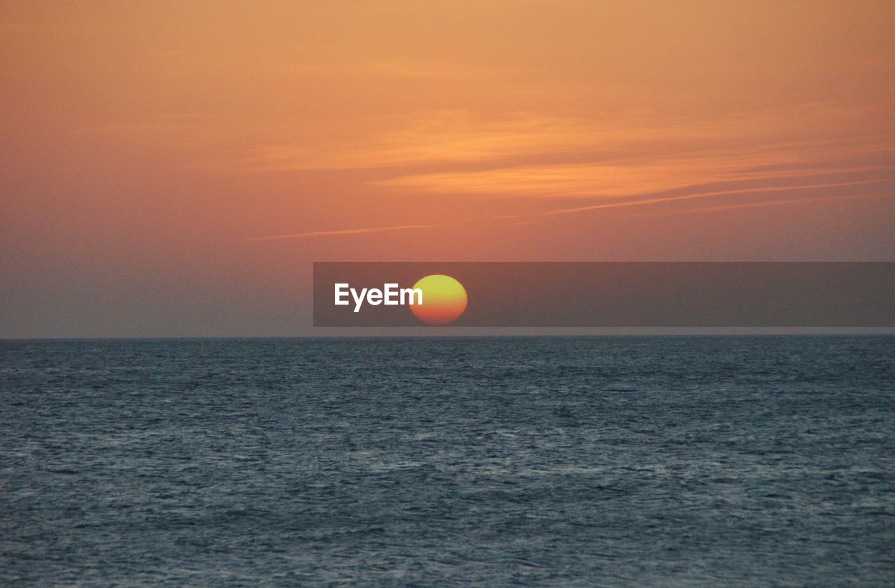 View of calm sea at sunset