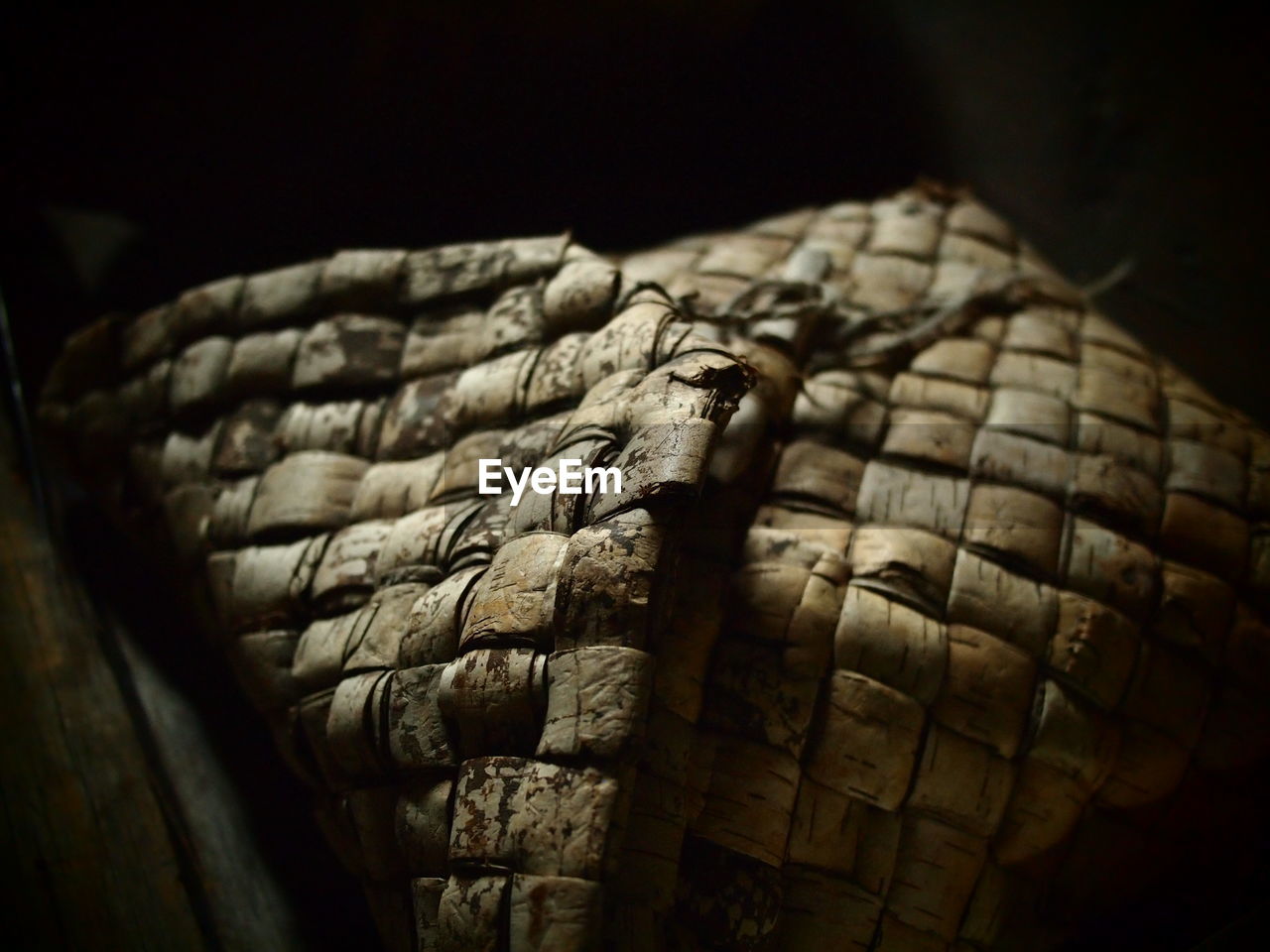 Close-up of wicker material in the dark