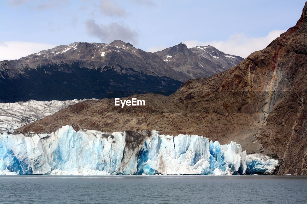 Spectacular mountain range with ice formed at the bottom