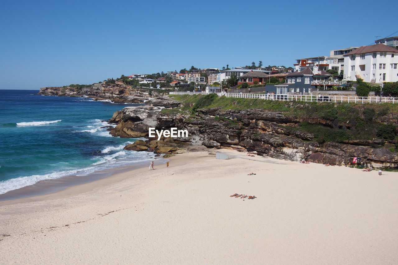 High angle view of beach and town against clear sky