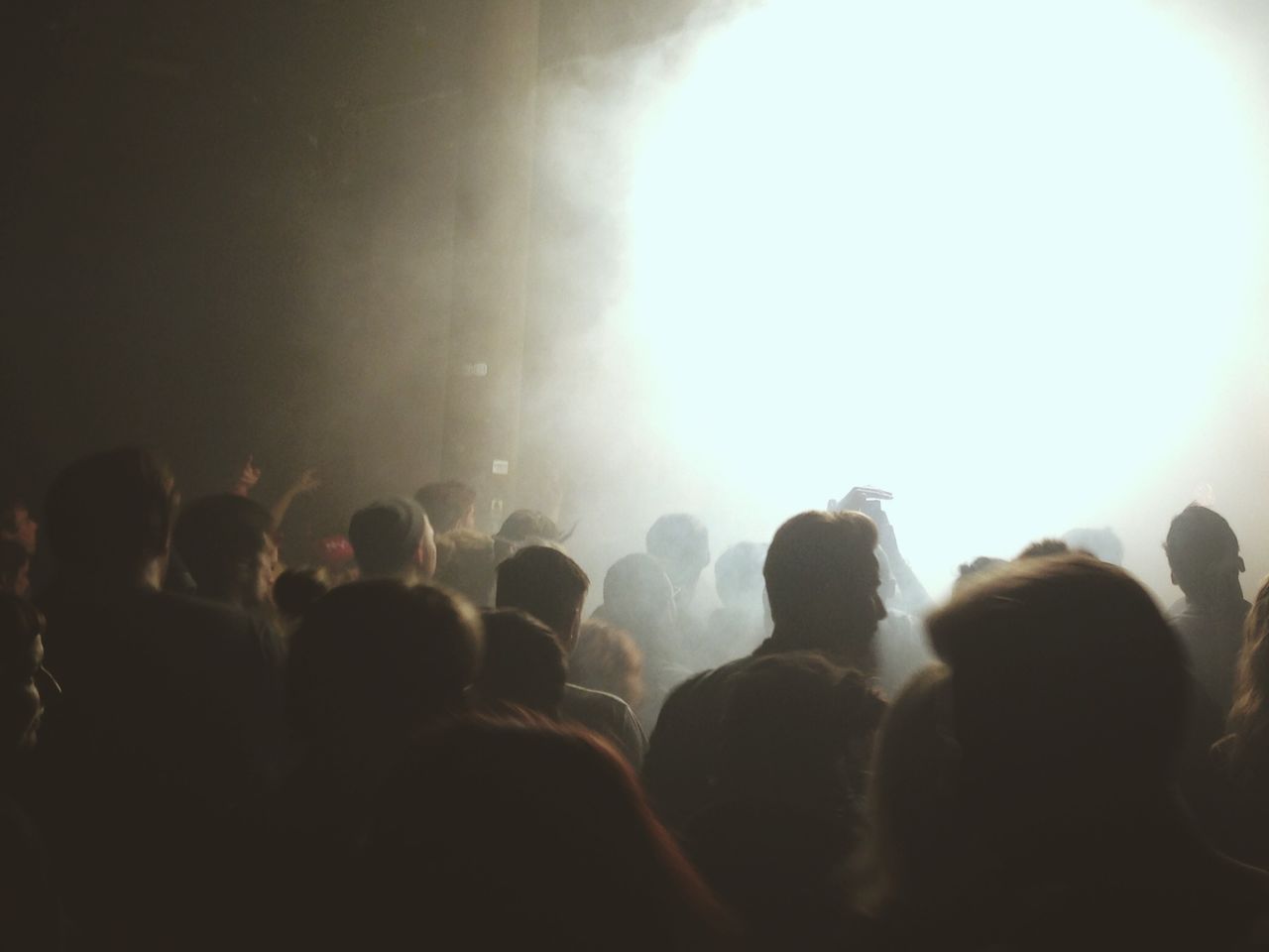 Crowd of people before illuminated stage