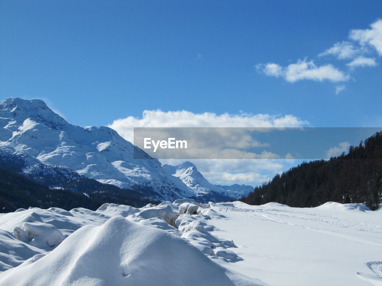 Snow covered landscape against mountain range