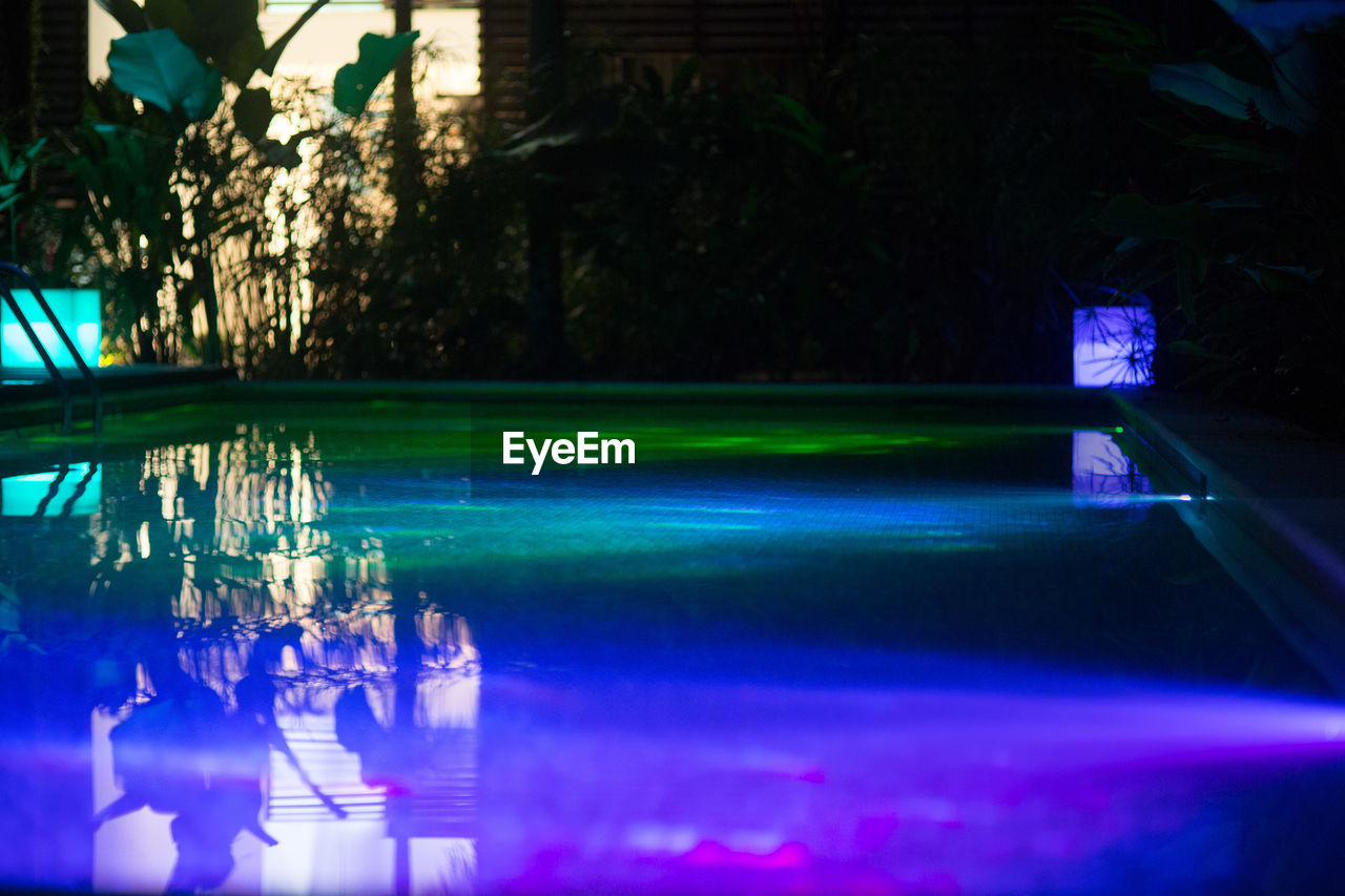 Reflection of lights in swimming pool at night