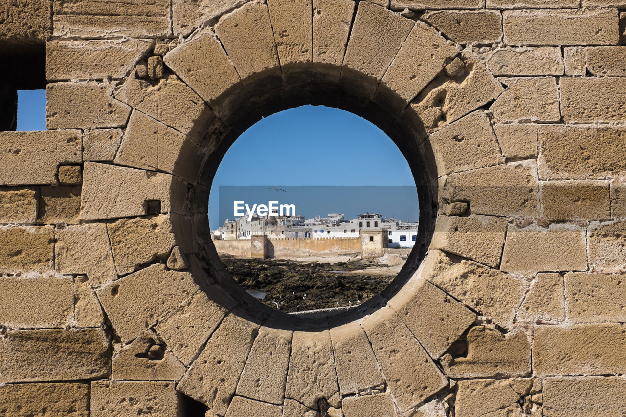 Old buildings seen through a round window