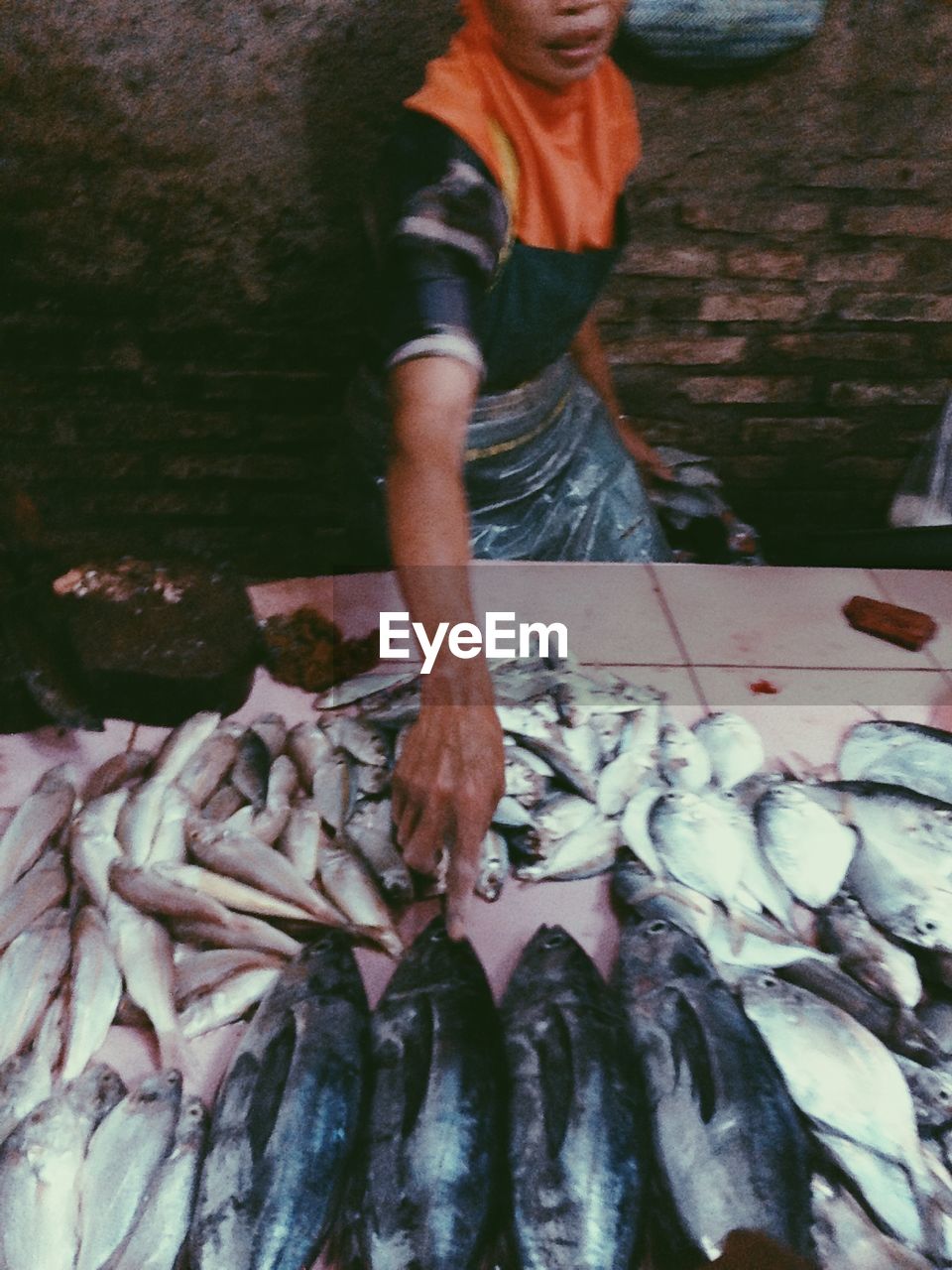 Mid section of a man selling fish