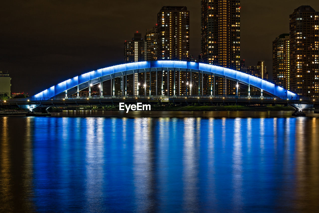 Blue eitai bridge with cityscape at night