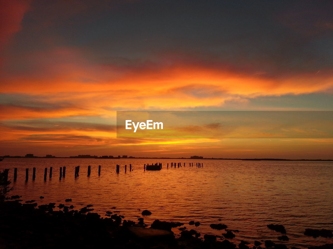 Cloudy sky above lake at sunset