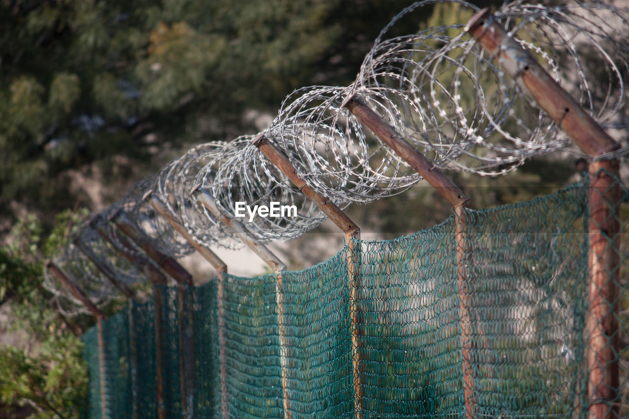 Barbed wire on chainlink fence