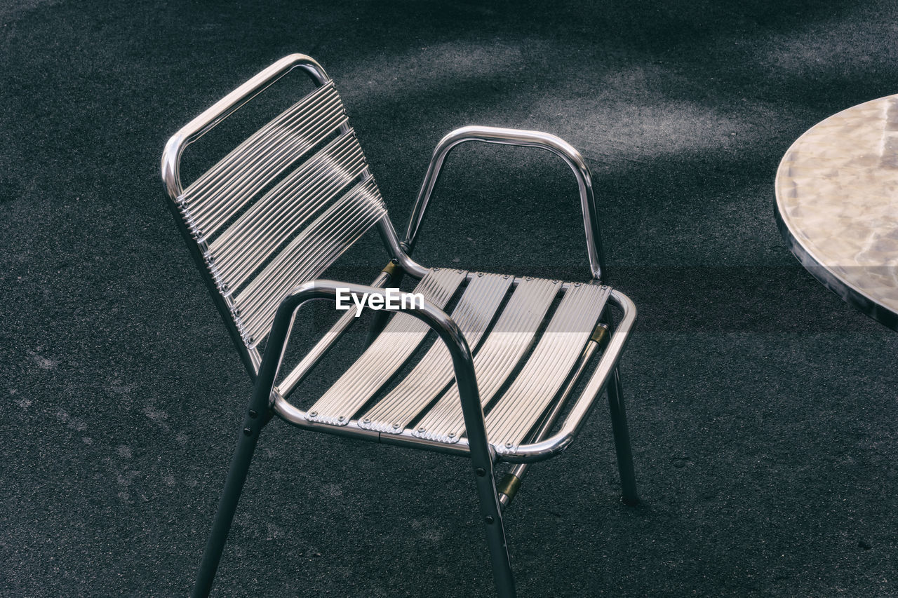 High angle view of aluminum chair on field