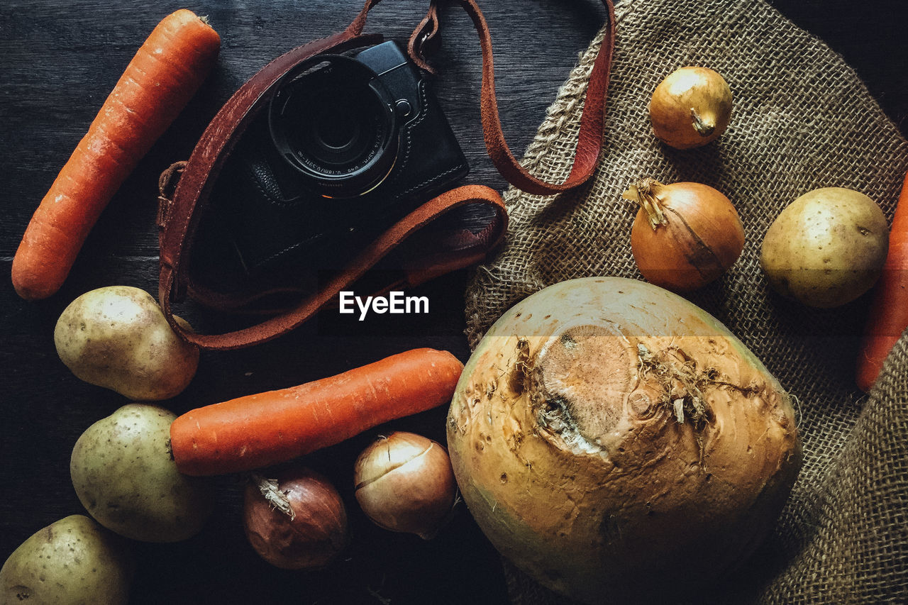 Close-up of vegetables and camera on table