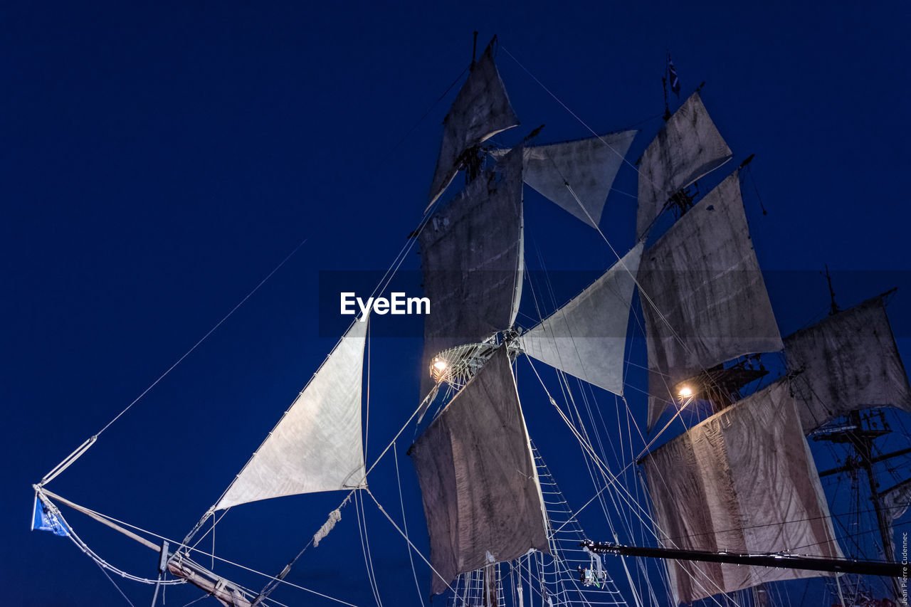 Low angle view of tall ship against clear sky at night