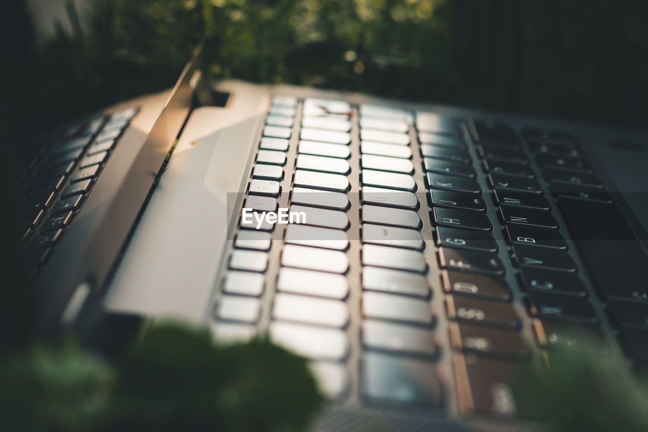 Close up shot of a laptop keyboard at golden hour outside