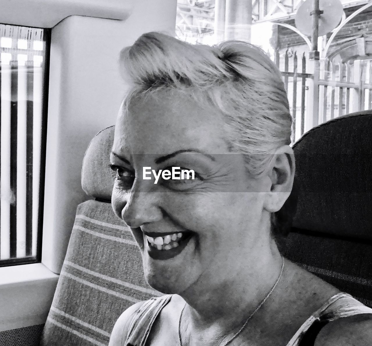 Close-up of smiling mature woman looking away in vehicle