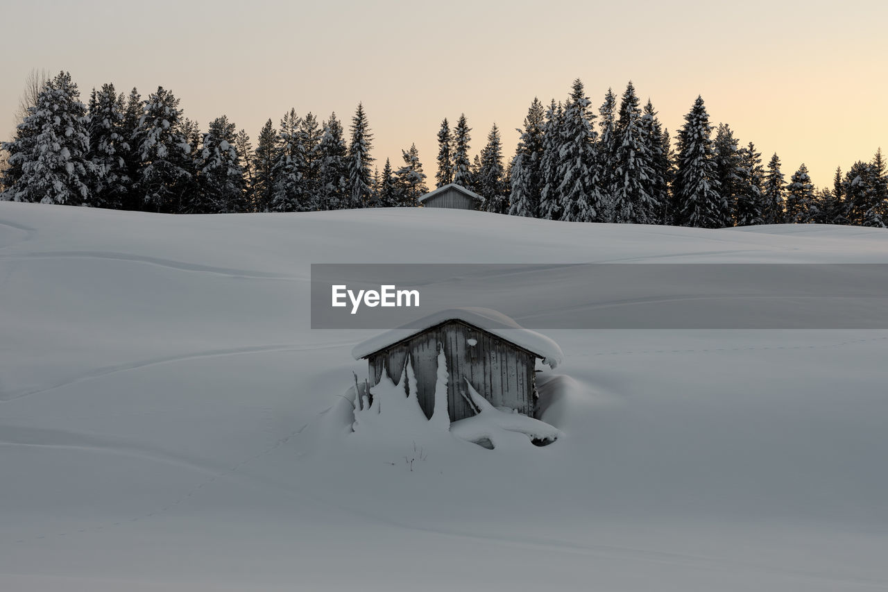 Scenic view of snowcapped landscape against sky during winter