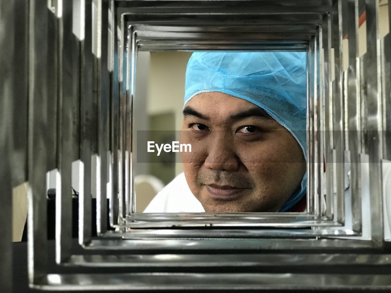 Portrait of smiling doctor wearing surgical cap