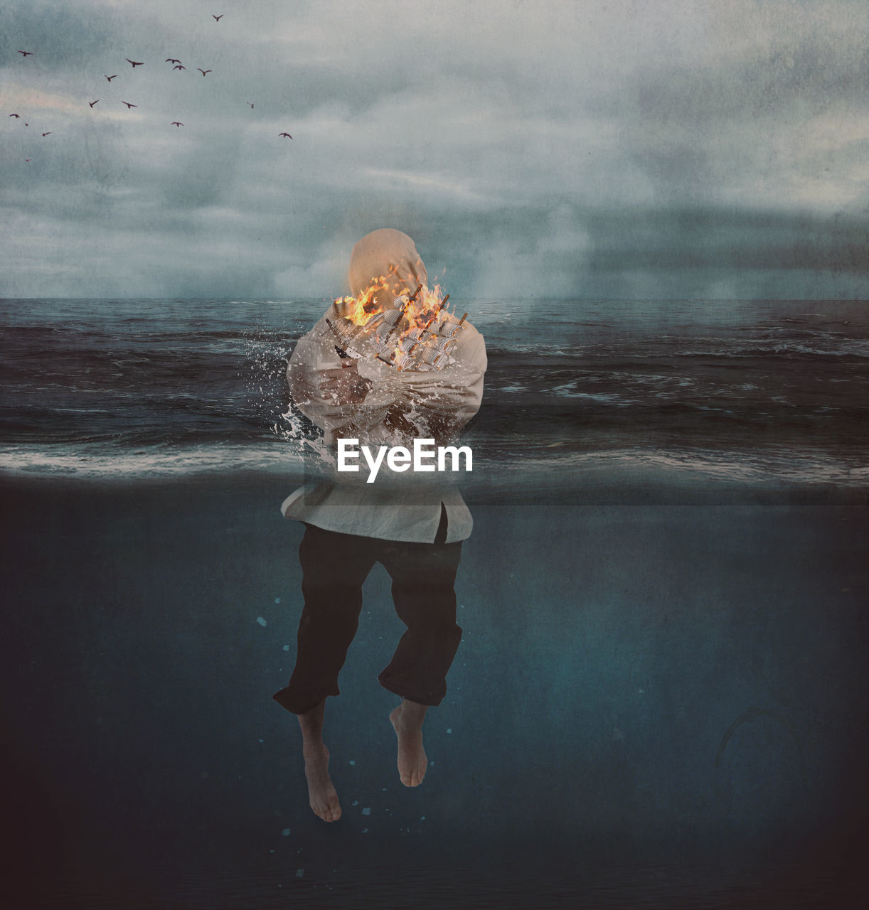 Digital composite image of man standing in sea
