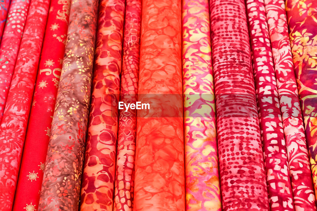 Detailed close up view on samples of cloth and fabrics in different colors found at a fabrics market