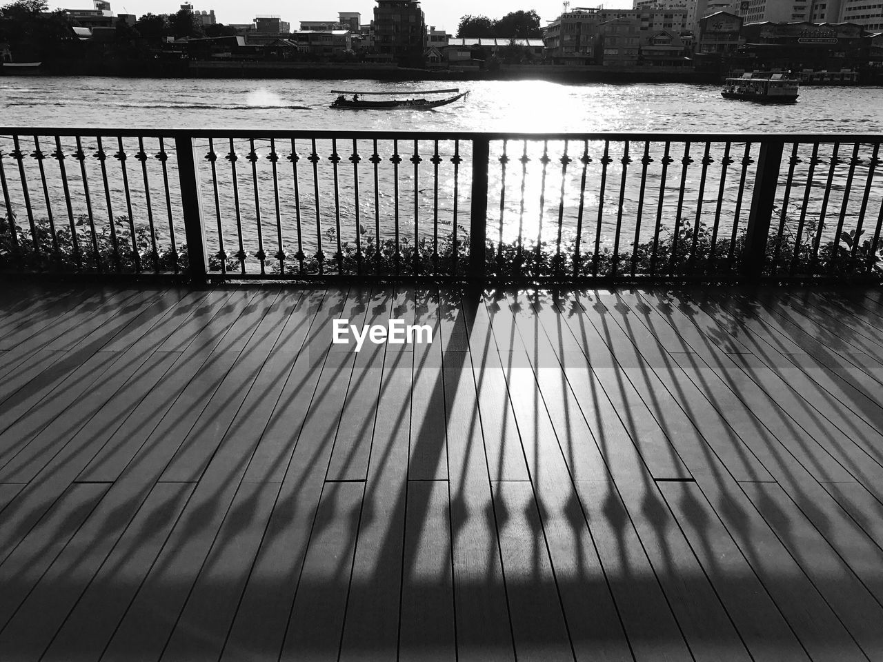 SHADOW OF RAILING IN RIVER