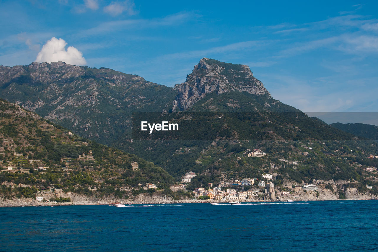 Scenic view of sea and mountains against sky