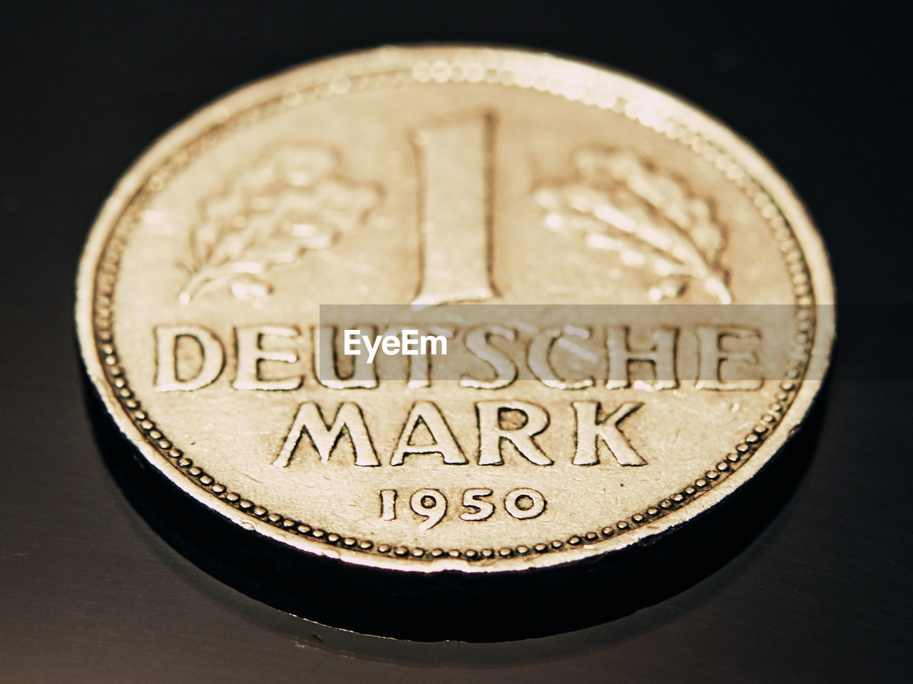 Close-up of one deutsche mark coin on table