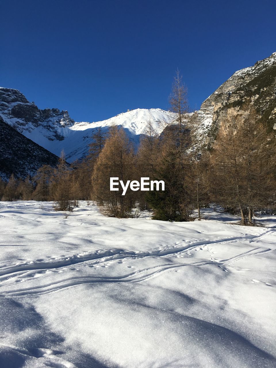 Scenic view of snowcapped mountains against clear sky