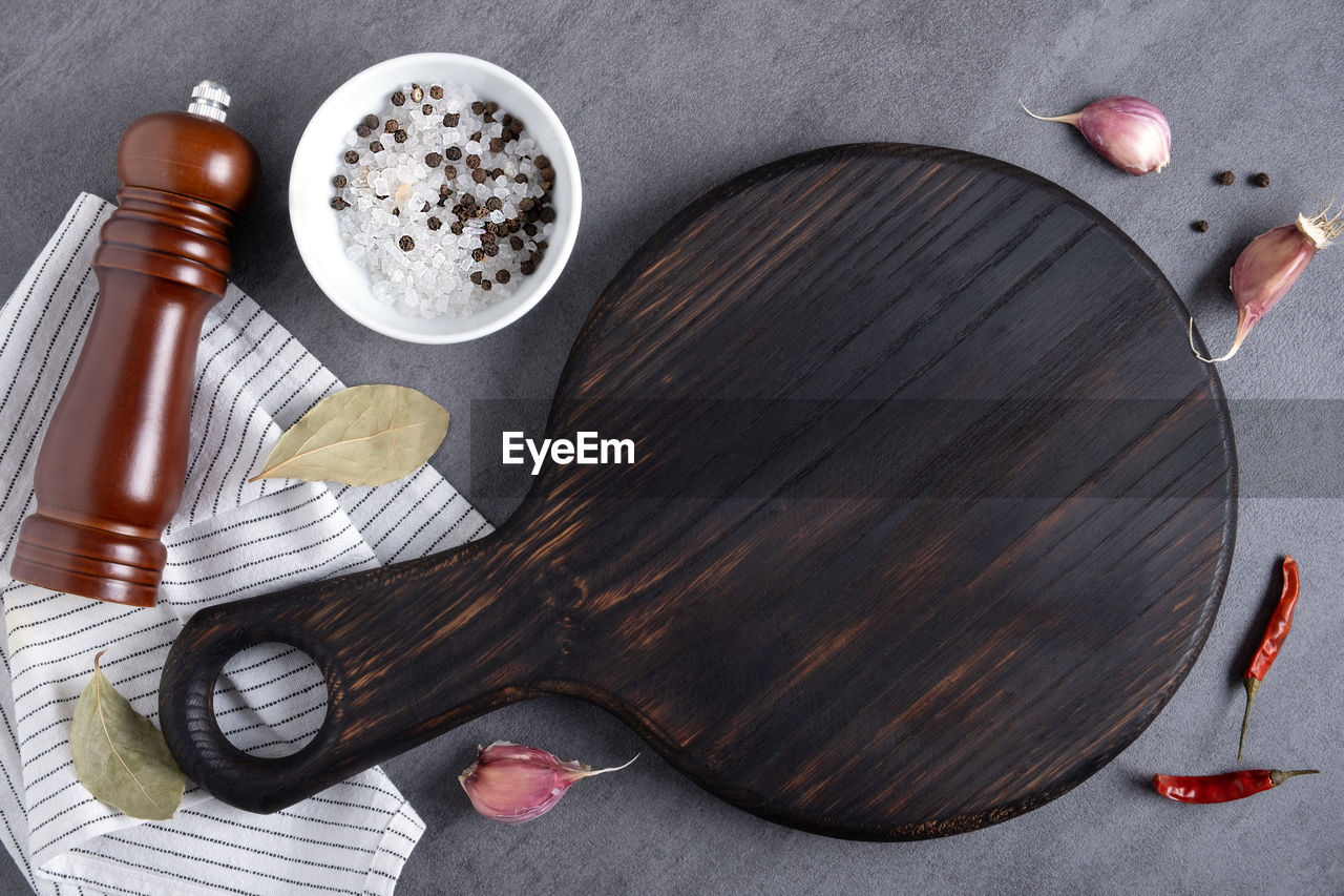 food and drink, kitchen utensil, food, plucked string instruments, household equipment, high angle view, indoors, wood, studio shot, directly above, no people, eating utensil, table, still life, string instrument, spoon, ingredient, still life photography, seasoning, guitar, art, gray