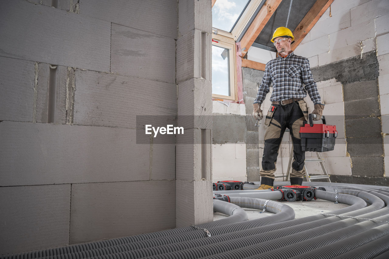 Full length of man standing at construction site