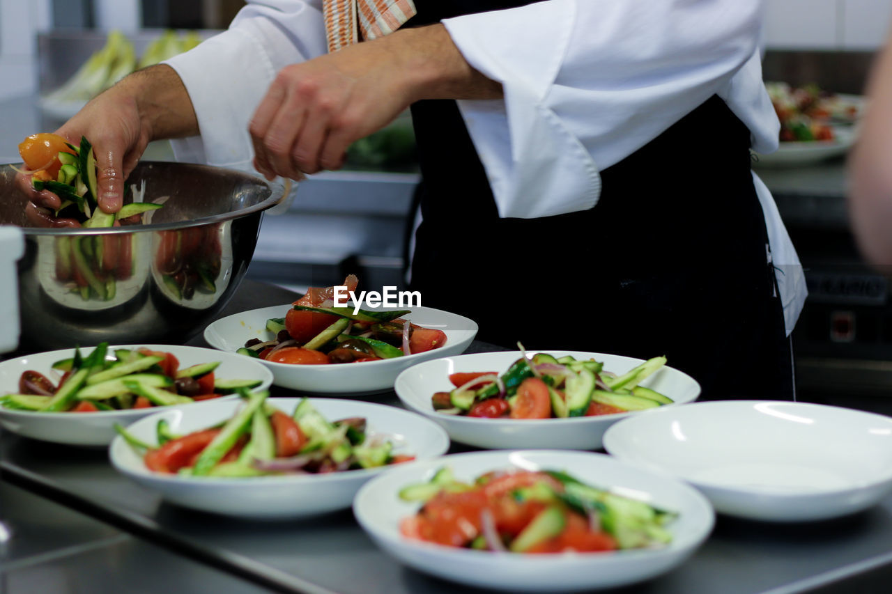 Midsection of chef preparing food in kitchen