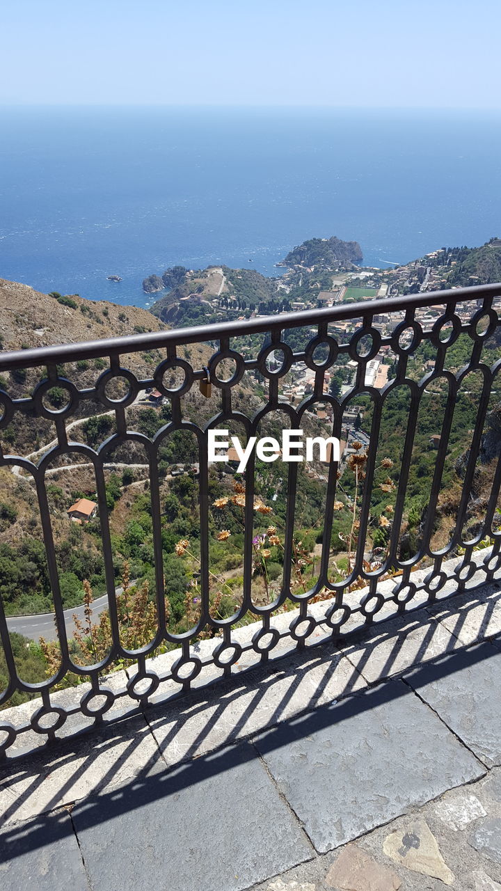 METAL GATE BY SEA AGAINST SKY