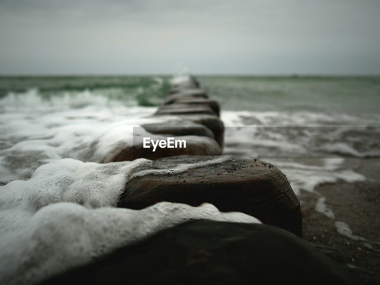 Pier at beach against sky